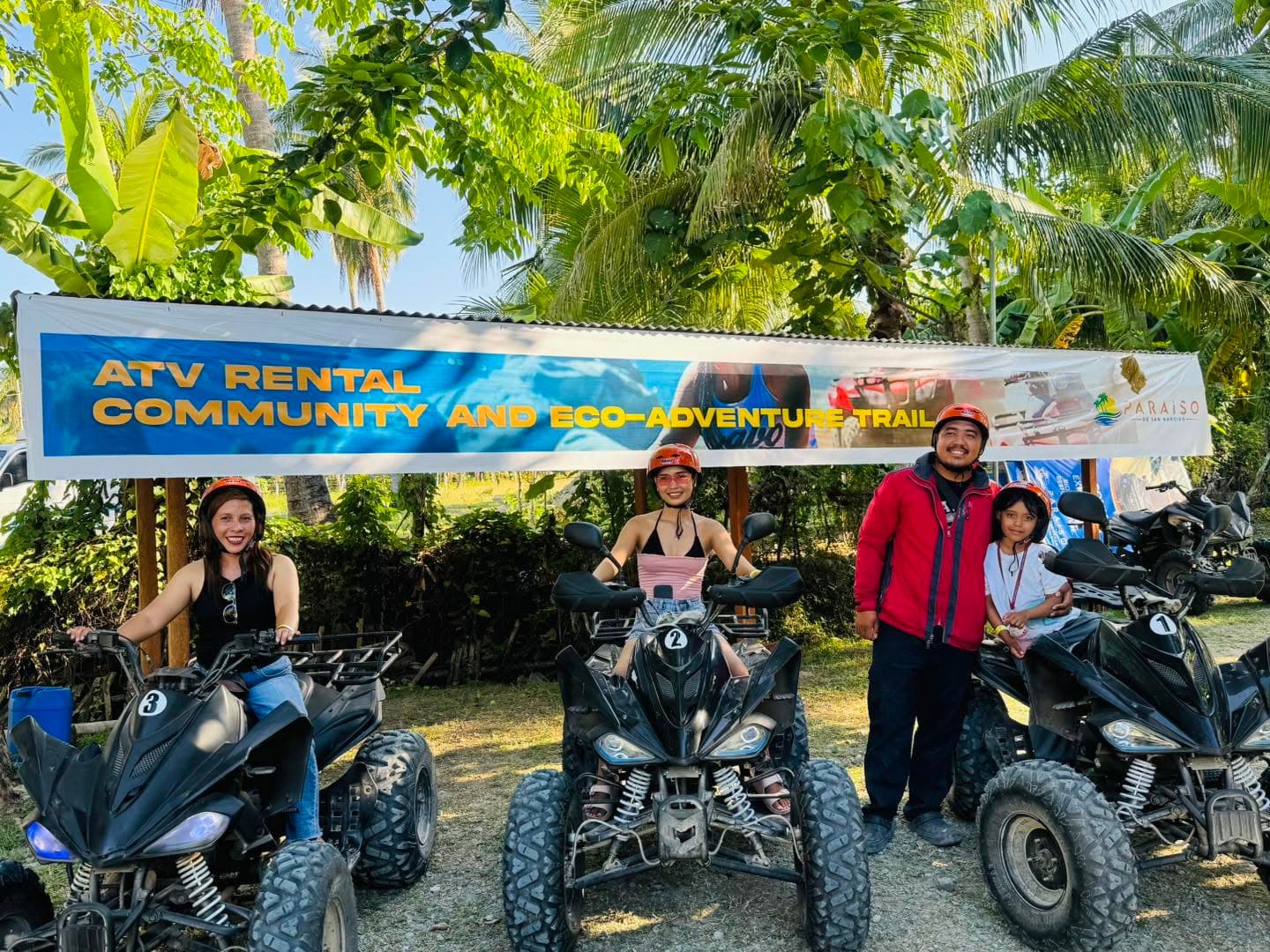 An ATV parked on the sand between rides