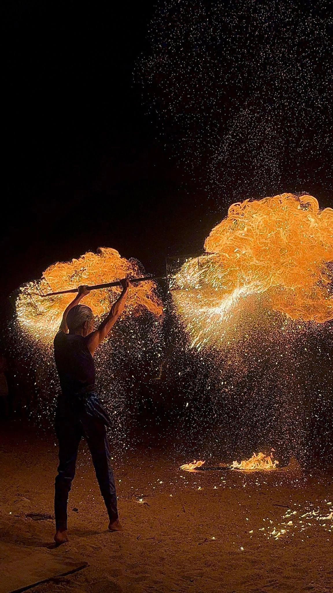 Evening fire performer by the beach