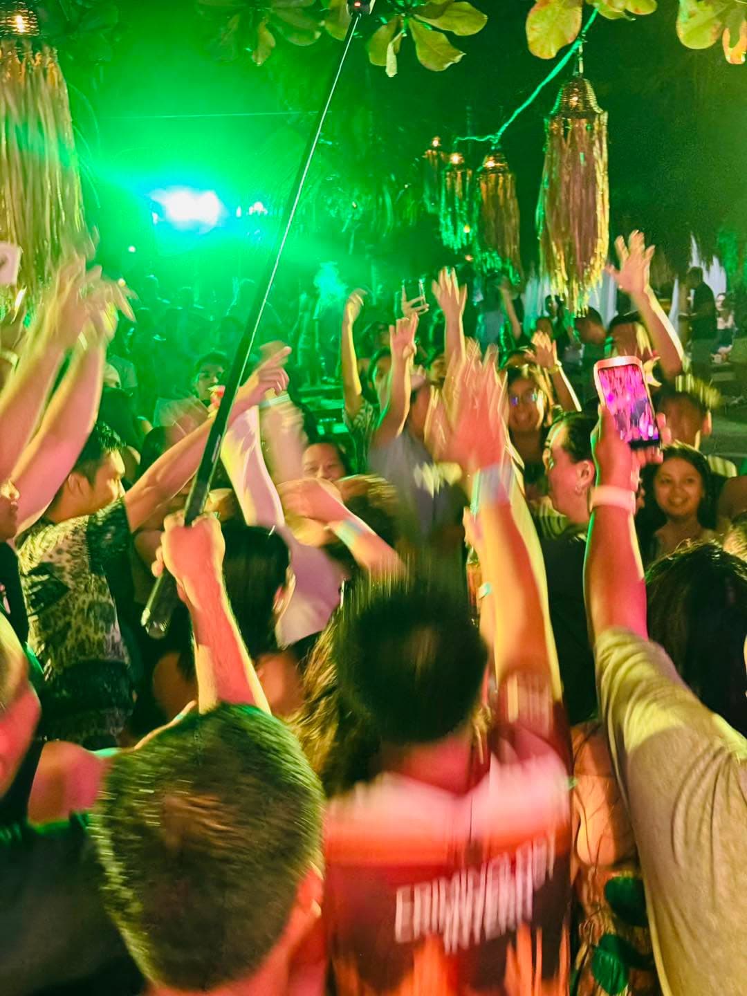 Guests gathered around the beach party bonfire